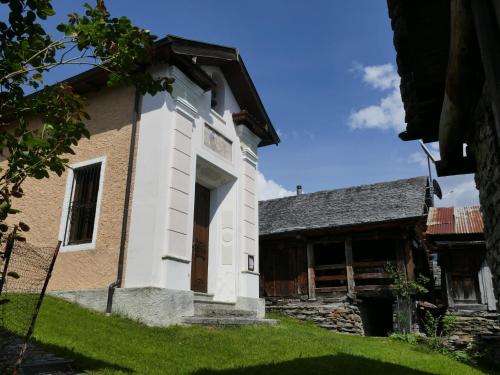 an old building with a door in a yard at Holiday Home Rustico Bel Panorama by Interhome in Malvaglia