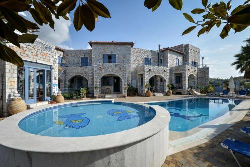 an estate with a swimming pool in front of a building at Taletos Apartments in Stoupa
