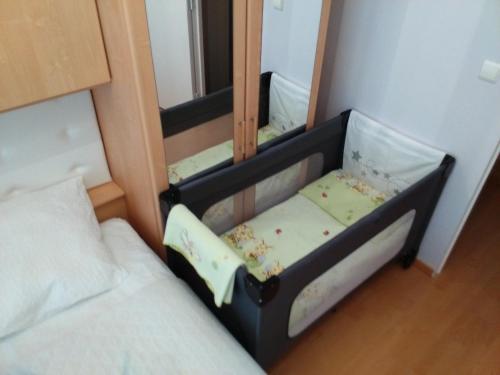 a small bed in a room with a mirror at Apartment Villa Ksenija in Ostend