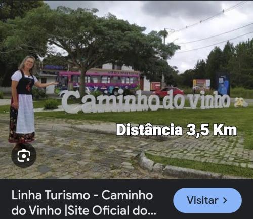 a woman standing on a skateboard in front of a sign at Apartamento in São José dos Pinhais