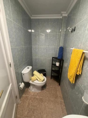 a bathroom with a toilet and yellow towels at Charming House in Costa Calma with Mountain View and Terrace in Costa Calma
