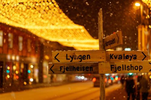 a street sign in a city at night at Arctic City Studio - perfectly located in the main street in Tromsø
