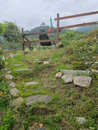 a garden with a swing and rocks on a hill at Agrihouseross in Mattie