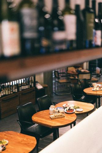 a restaurant with tables and chairs with food on them at Olive hotel in Yerevan