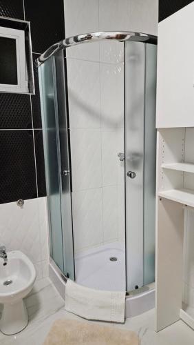a shower with a glass door in a bathroom at M&M Bazen resort Goražde in Goražde