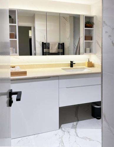 une salle de bain avec un lavabo et un miroir dans l'établissement Saint Tropez centre en style Piscine AC mer 100m, à Saint-Tropez