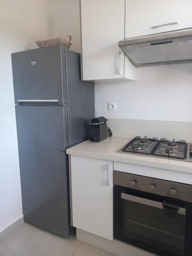 a kitchen with a refrigerator and a stove at Soleil & Compagnie Cabo Huerto in Cabo Negro
