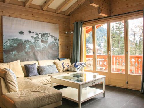 a living room with a couch and a coffee table at Apartment Muscardin 5-6 by Interhome in Chesières