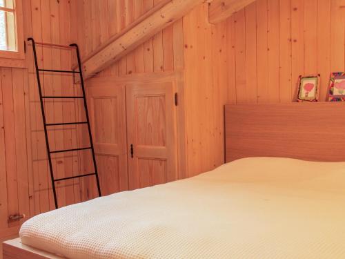 a bedroom with a ladder next to a bed at Apartment Muscardin 5-6 by Interhome in Chesières