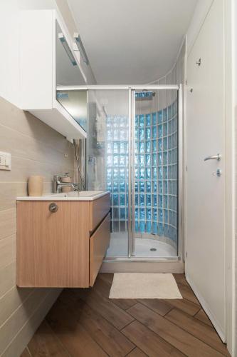a bathroom with a sink and a shower at Glass Loft in Milan