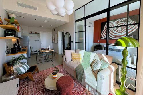 a living room with a couch and a table at Oraya - Collective 2 0 Tower A Sanctuary in Dubai Hills in Dubai