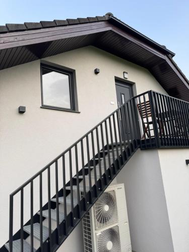 a building with a staircase and a window at Holiday home Ana in Fokovci