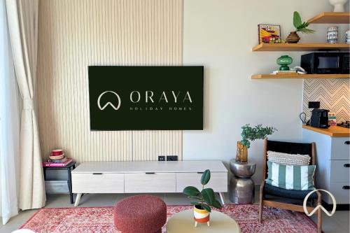 a living room with a white table and a green sign on the wall at Oraya - Collective 2 0 Tower A Sanctuary in Dubai Hills in Dubai