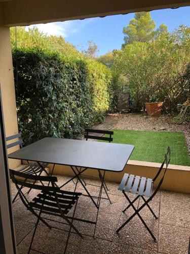 - une table blanche et 2 chaises sur la terrasse dans l'établissement Studio 4pers Bord de mer et jardin, à Saint-Raphaël