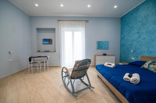a bedroom with a bed and a chair and a desk at Camerelle Apartments - casa vacanze in Castellammare di Stabia