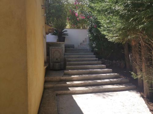 a stairway leading up to a building with plants at Maison de Charme en couleurs in Cuers