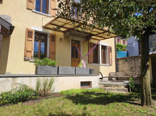 a house with a bench in front of it at Les Jardins du Chateau in Annecy