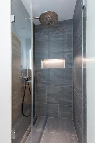 a bathroom with a shower with a glass door at Koller Furggahorn by Arosa Holiday in Arosa