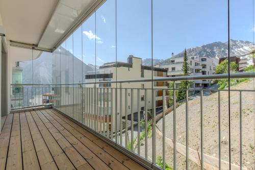 a balcony with a view of a city at Koller Furggahorn by Arosa Holiday in Arosa