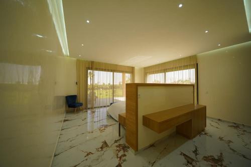 a bedroom with a bed and a desk in it at Superbe Villa Éco avec Piscine in Agadir