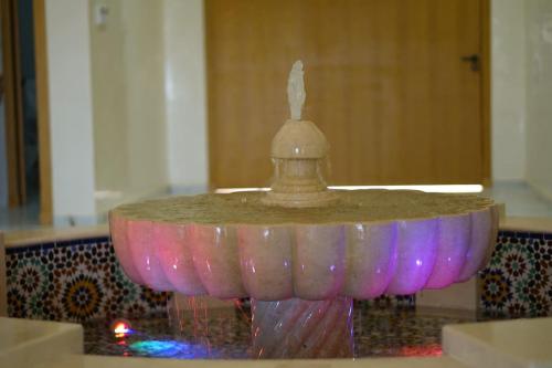 a pink and purple fountain in a room at Superbe Villa Éco avec Piscine in Agadir