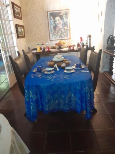 a table with a blue table cloth on it at Flat Muqui 91 in Teresópolis