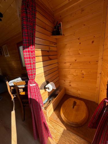 an inside view of a log cabin with a wooden tub at La Rouloulotte in Durbuy
