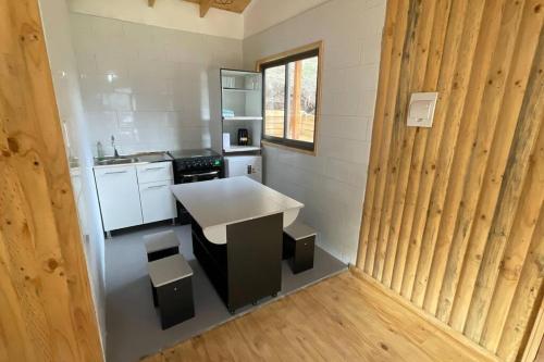 a small kitchen with a white counter in a room at Cabañas del Maipo - Cabaña Tupungato in Santiago