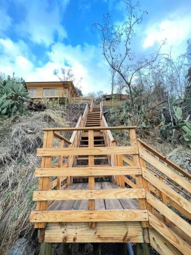 a wooden bridge leading up to a house at Cabañas del Maipo - Cabaña Tupungato in Santiago