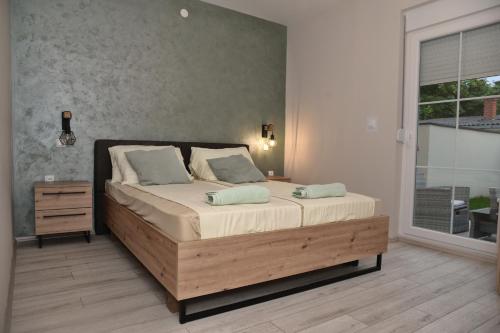 a bedroom with a large bed and a window at 4-teen in Jagodina