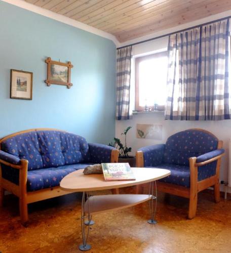 a living room with a couch and a table at SchwarzWild - Ferienwohnung und Ferienzimmer in Baiersbronn