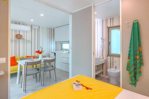 a room with a kitchen and a dining room at Camping Village Riva Blu in Padenghe sul Garda