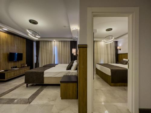 Postel nebo postele na pokoji v ubytování Quality Gold Suite Hotel