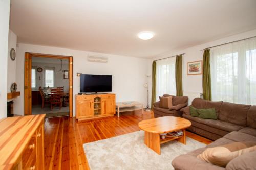 a living room with a couch and a table at Levendula Villa in Balatonőszöd