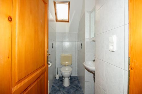a bathroom with a toilet and a sink at Levendula Villa in Balatonőszöd