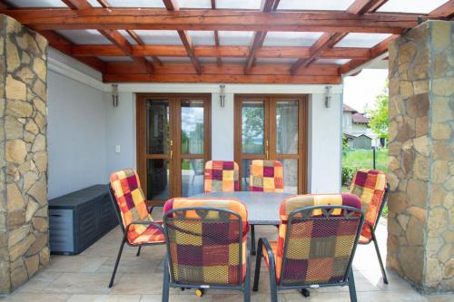 a patio with a table and chairs on a patio at Levendula Villa in Balatonőszöd