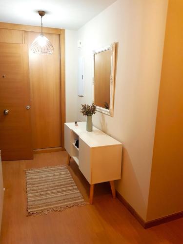 a bathroom with a white dresser and a mirror at Taboada Sacra Home in Taboada