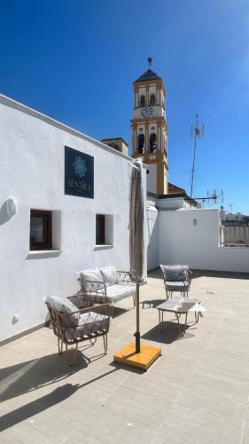 a building with a clock tower on top of it at Selecta Marbella Sentire Apartaments in Marbella