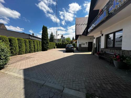 a car parked in front of a building at DW Basia pokoje i apartament in Białka Tatrzanska
