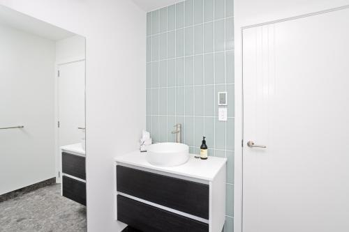 a bathroom with a sink and a mirror at Southern Breeze - Colac Bay Beach House in Riverton