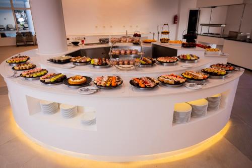 a buffet line with many different types of desserts at Royal Tulip Taj Sultan in Hammamet
