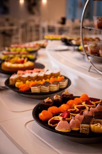 a row of plates of food on a table at Royal Tulip Taj Sultan in Hammamet