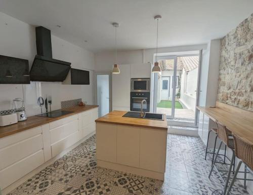 une cuisine avec un évier et un plan de travail dans l'établissement à 5mn de la réserve Africaine, charmante maison de village avec patio, à Sigean