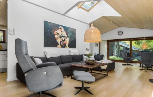 a living room with a couch and a table and chairs at Awesome Home In Græsted With Sauna in Græsted