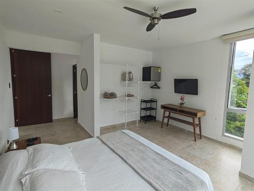 a bedroom with a bed and a ceiling fan at Montecarlo Club in La Mesa