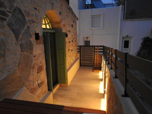 an aisle of a church with a door and benches at Fabrica House in Mochlos