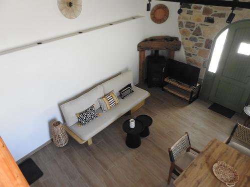 a living room with a couch and a fireplace at Fabrica House in Mochlos