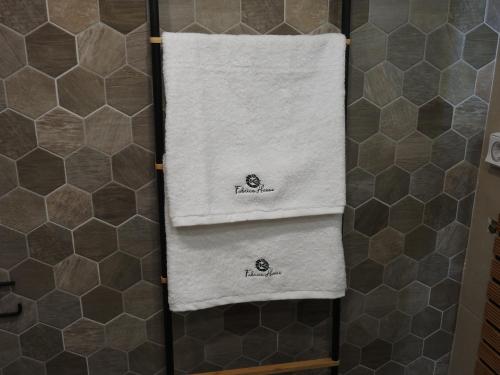 a bathroom with three towels on a shower stall at Fabrica House in Mochlos