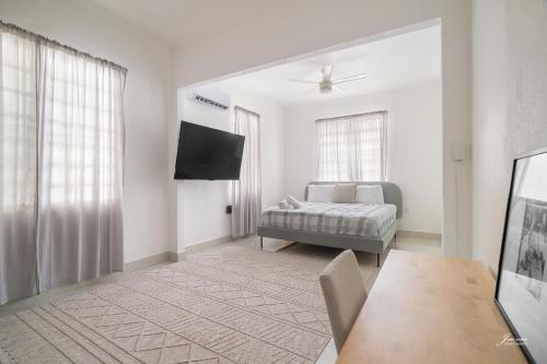 a living room with a bed and a television at SAN JUAN Villa - Laplacita in San Juan