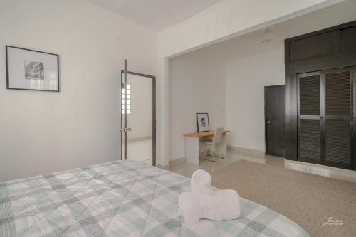 a white bedroom with a large bed and a table at SAN JUAN Villa - Laplacita in San Juan